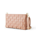 Woven leather crossbody clutch in blush pink - side angle product view on white background