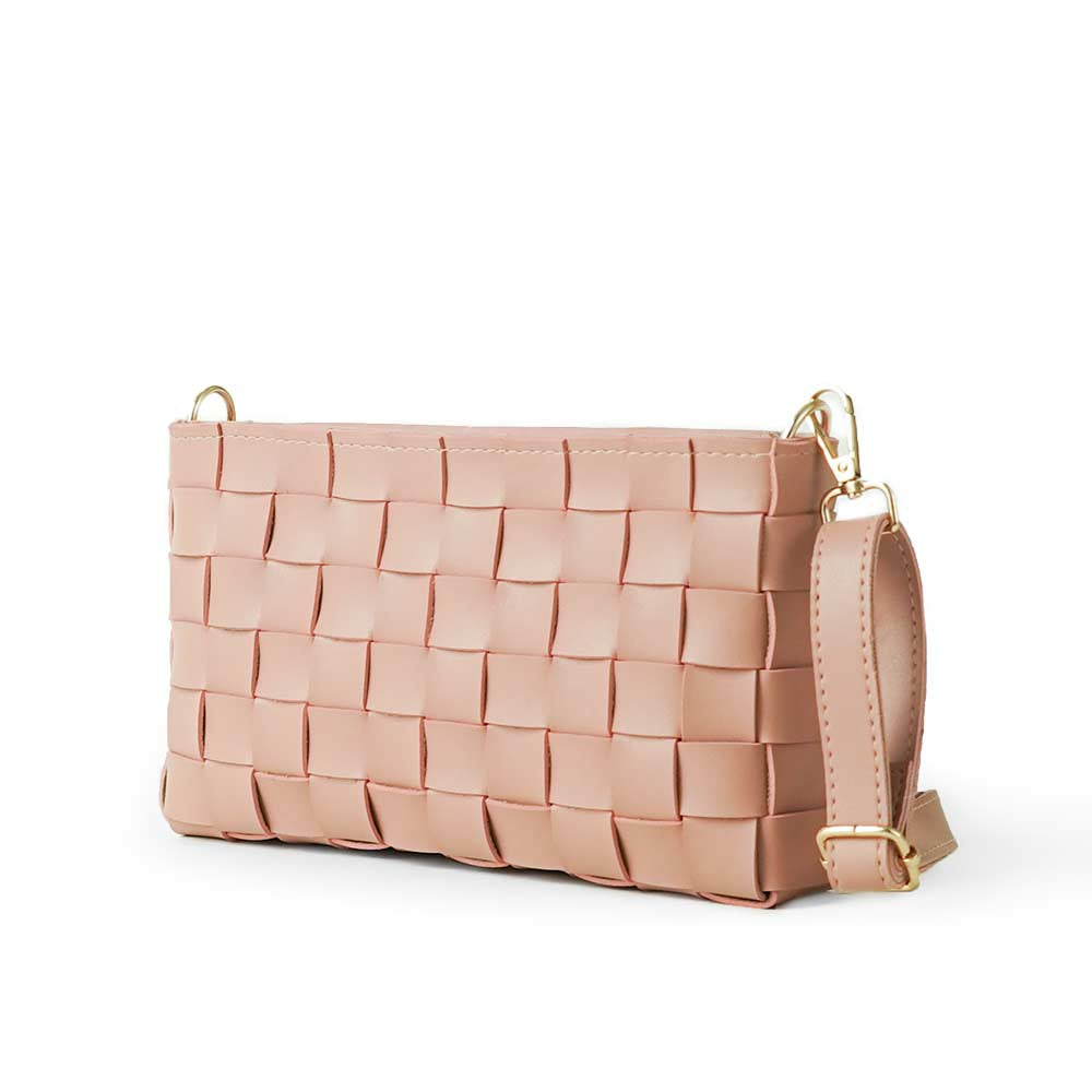 Woven leather crossbody clutch in blush pink - side angle product view on white background