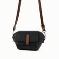 Saffiano flap crossbody bag in black - model wearing as crossbody with pink embroidered outfit back view