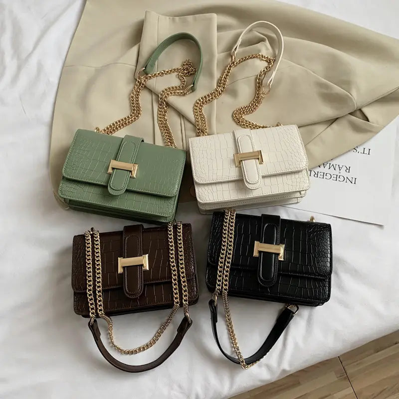 Croc T-lock chain crossbody bag in all colors - orange, green, white and black flat lay