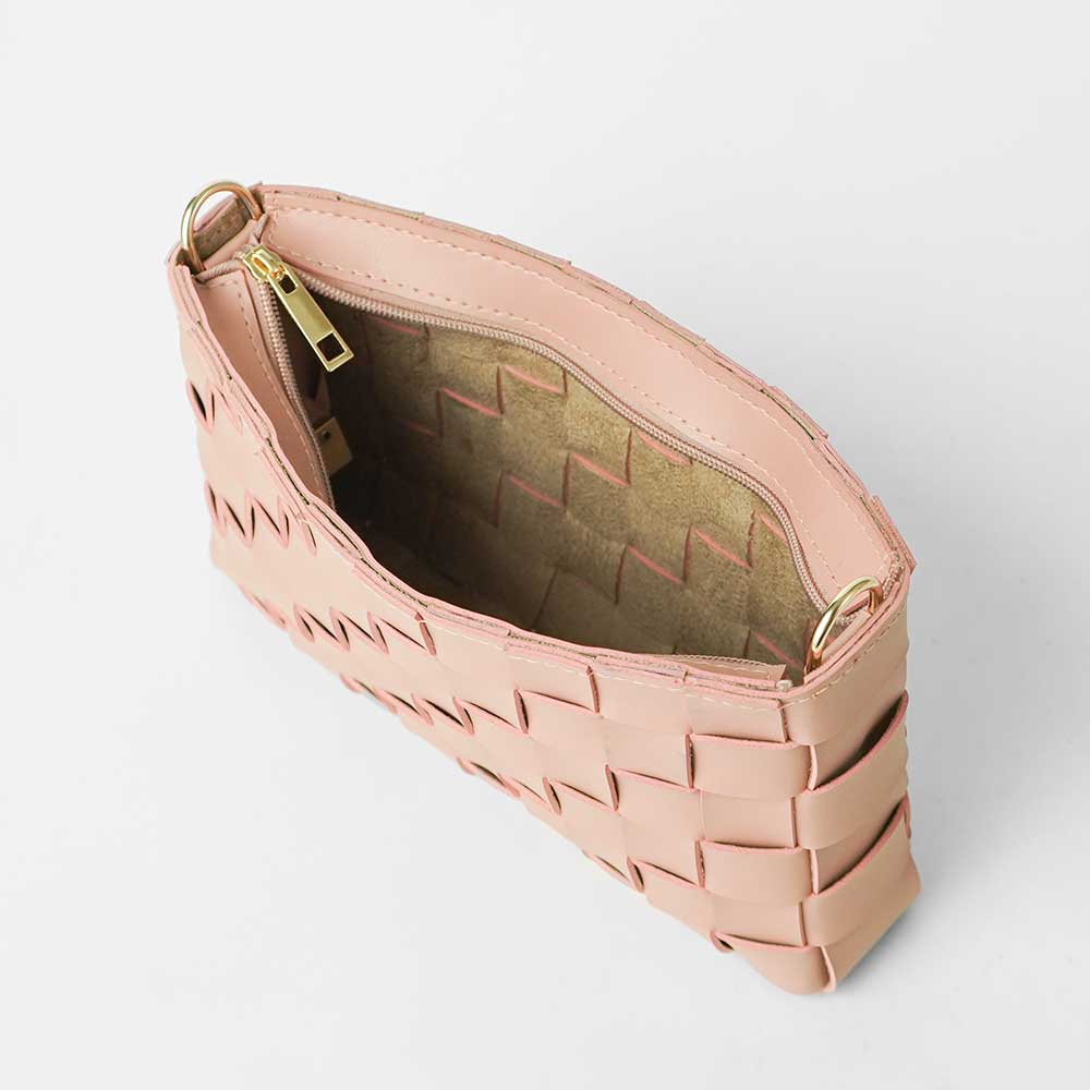 Woven leather crossbody clutch in blush pink - open interior view showing woven lining