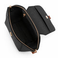 Saffiano flap crossbody bag in black - model wearing as crossbody with pink embroidered outfit front view
