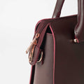 Maroon structured top handle handbag - open interior view showing spacious burgundy velvet lining