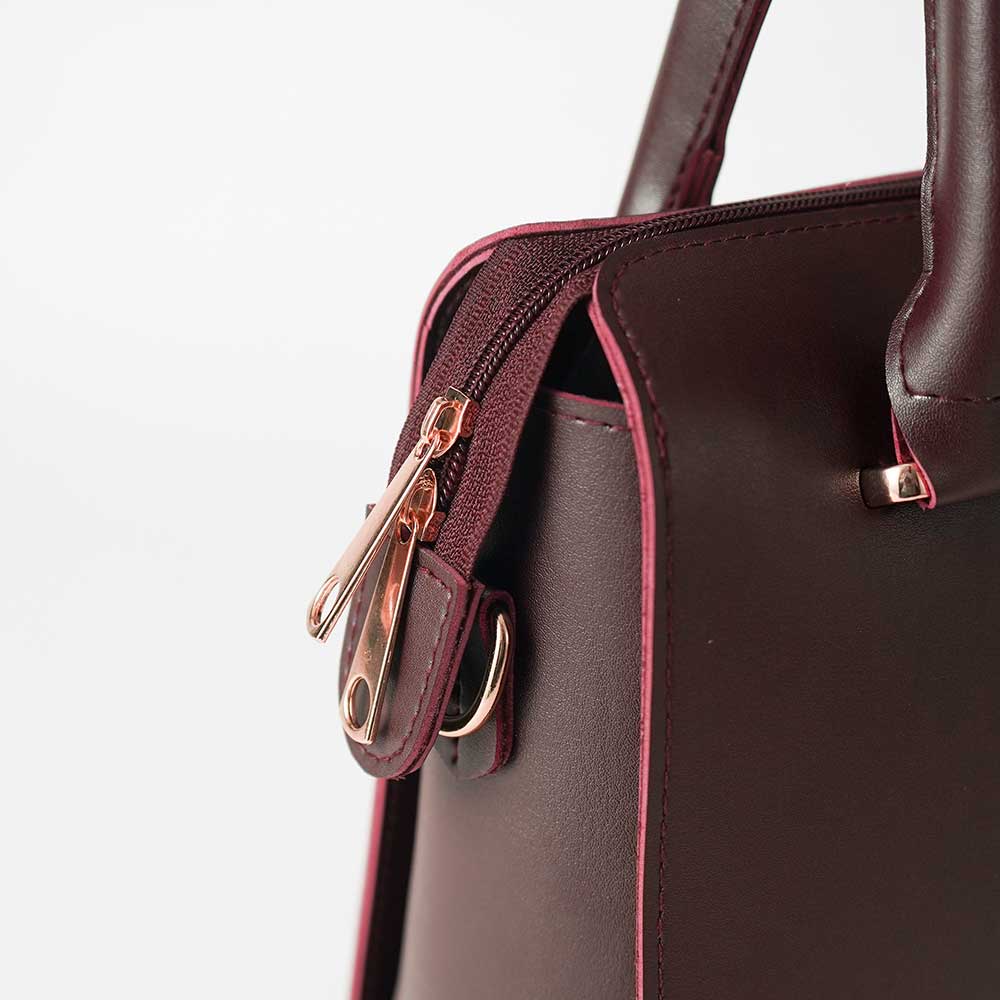 Maroon structured top handle handbag - open interior view showing spacious burgundy velvet lining