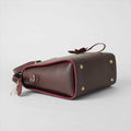 Maroon structured top handle handbag - front product view on white background with crossbody strap