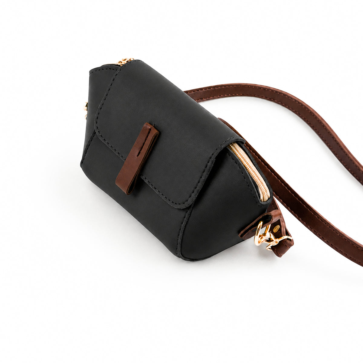 Saffiano flap crossbody bag in black - close-up of gold carabiner clip and brown strap attachment