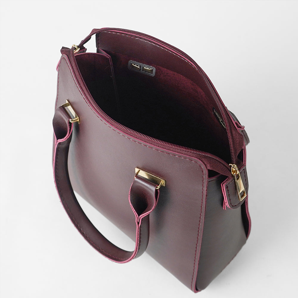 Maroon structured top handle handbag - side profile view on white background showing pink piping trim