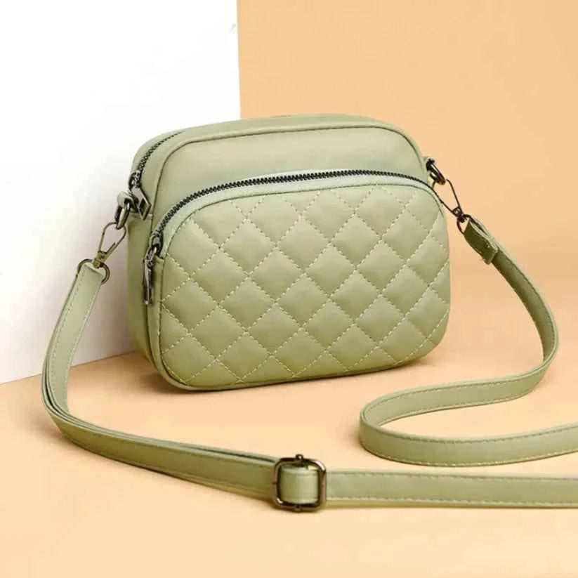 Mint green quilted crossbody bag - model wearing with striped top