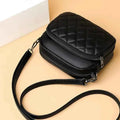 Quilted crossbody bag interior close-up with zipper pockets