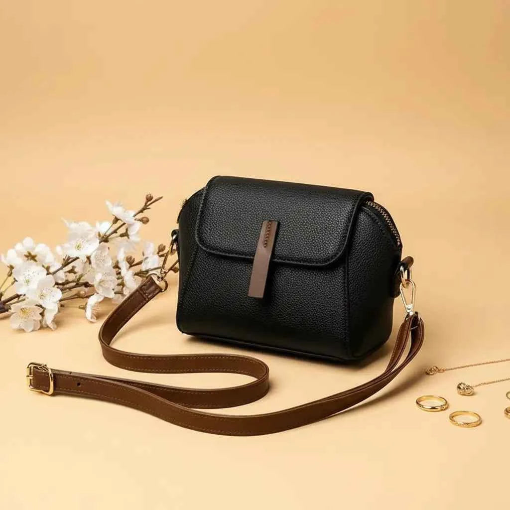 Cavelle crossbody purse in black - angle view with strap