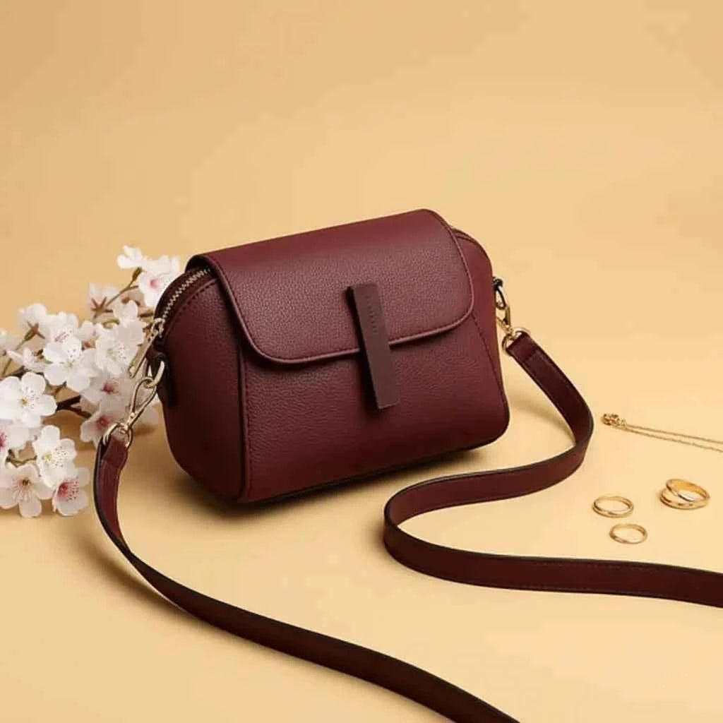 Cavelle crossbody purse in maroon - angle view with strap