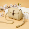 Cavelle crossbody purse in skin/beige - angle view with strap