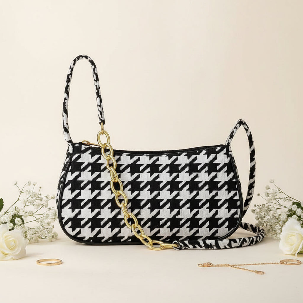 Chic houndstooth shoulder bag - model holding as underarm clutch