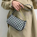 Chic houndstooth shoulder bag - product side angle view on white background