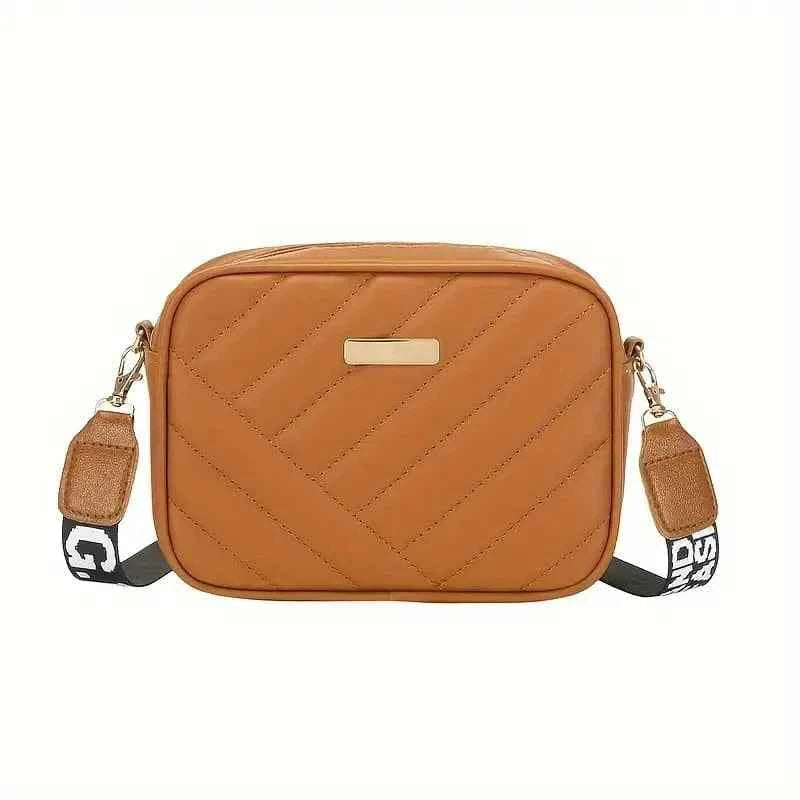 Elorina luxe crossbody bag in beige - lifestyle front view with flowers