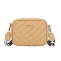 Elorina luxe crossbody bag in pink - lifestyle front view with flowers