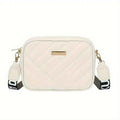 Elorina luxe crossbody bag in tan/brown - lifestyle front view with flowers