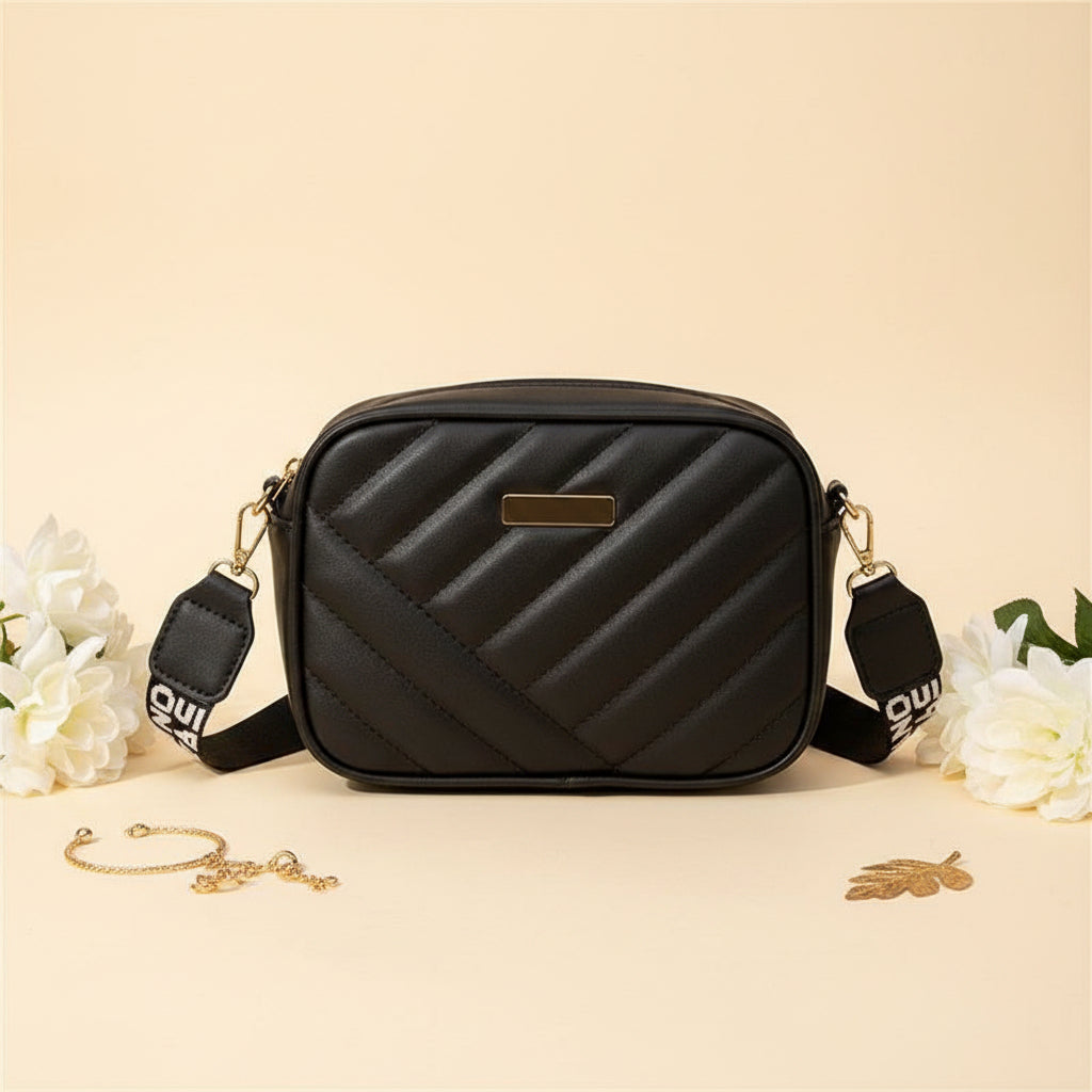 Elorina luxe crossbody bag in maroon - lifestyle front view with flowers