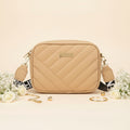Elorina luxe crossbody bag in white - lifestyle front view with gold accessories