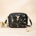 Embroidered butterfly crossbody bag in black - model lifestyle side view