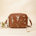 Embroidered butterfly crossbody bag in brown - product front view