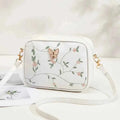 Embroidered butterfly crossbody bag - 3D butterfly charm close-up