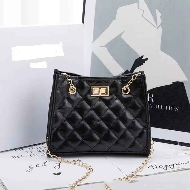 Laila mini chain satchel in black - editorial side view on fashion magazine
