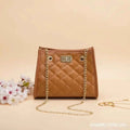 Laila mini chain satchel in camel - lifestyle front view with flowers