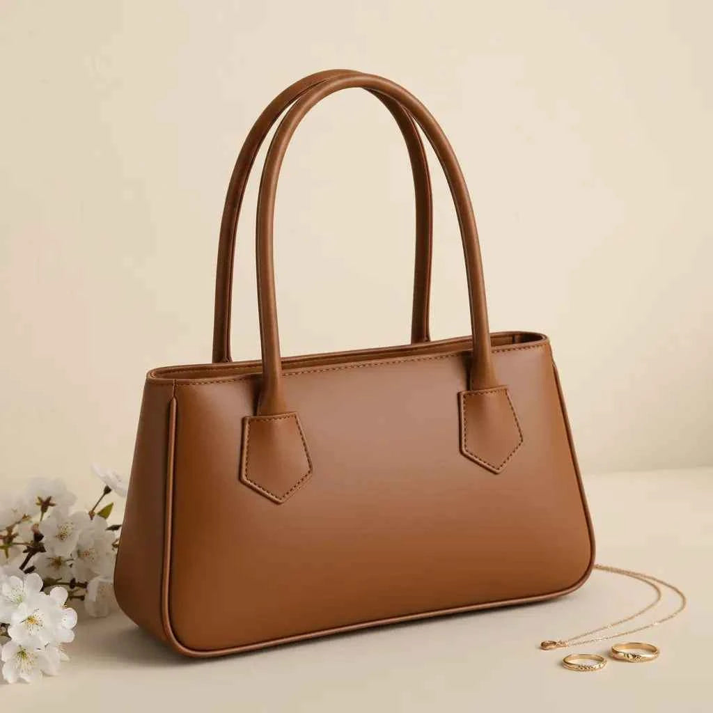 Mahveen elegant ladies handbag in camel - side angle view with white flowers and gold chain