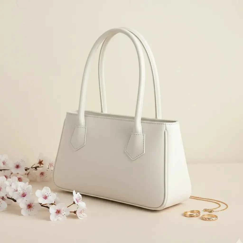 Mahveen elegant ladies handbag in white - side angle view with pink flowers and gold accessories