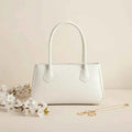 Mahveen elegant ladies handbag in white - front view with white flowers and gold necklace