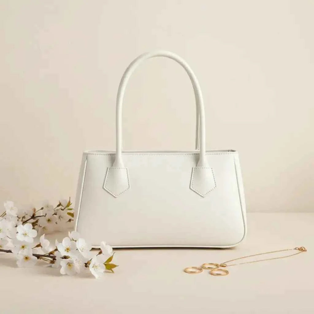 Mahveen elegant ladies handbag in white - front view with white flowers and gold necklace
