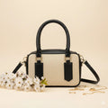 Noor classic handbag in black trim - front view with white flowers and gold accessories