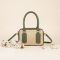 Noor classic handbag in olive green trim - front view with white flowers and gold accessories