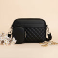 Quilted crossbody bag with coin pocket in black - lifestyle front view with white flowers and gold chain