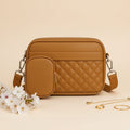 Quilted crossbody bag with coin pocket in brown/tan - lifestyle front view with white flowers and gold rings