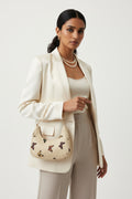 Rangon Ki Titli butterfly print bag - model wearing as shoulder bag with cream blazer and pearl necklace