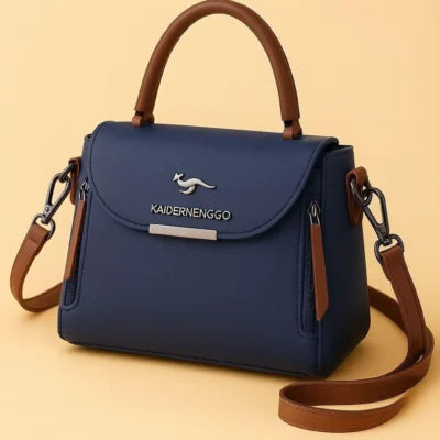 Kaidernenggo two-tone handbag in navy blue with brown trim - product front angle view on yellow background